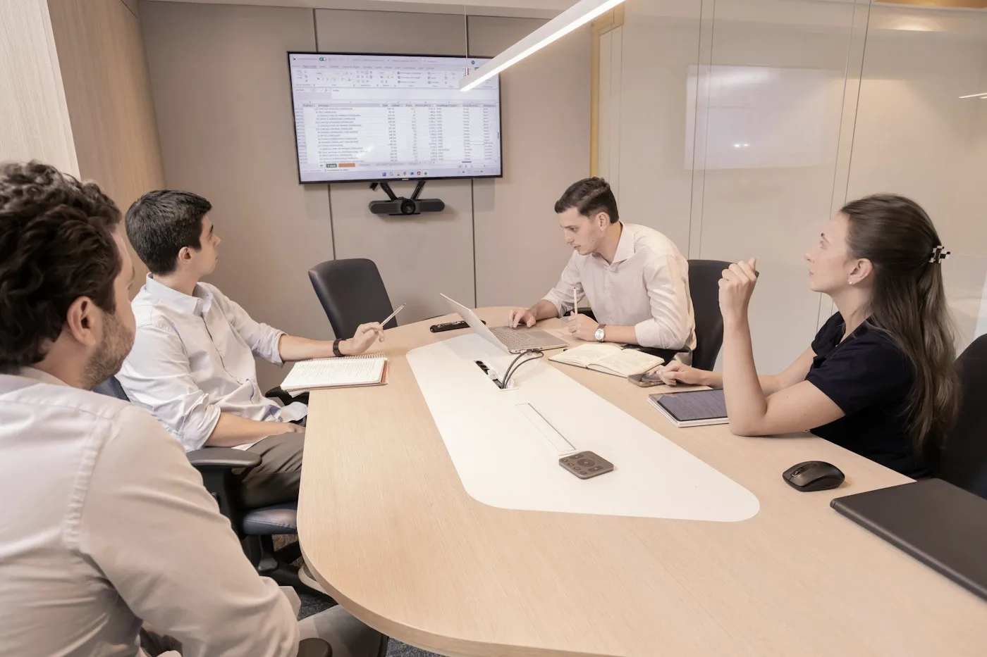 Professionals discussing plans around a meeting table